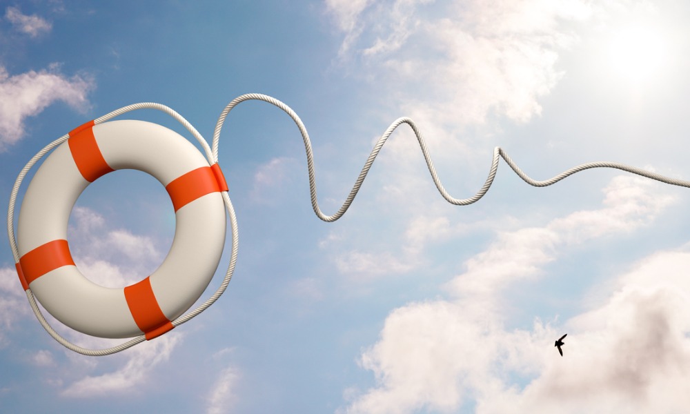a life preserver attached to a rope, airborne in a blue sky